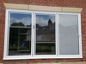 White Aluminium Bifolding doors with integral blinds